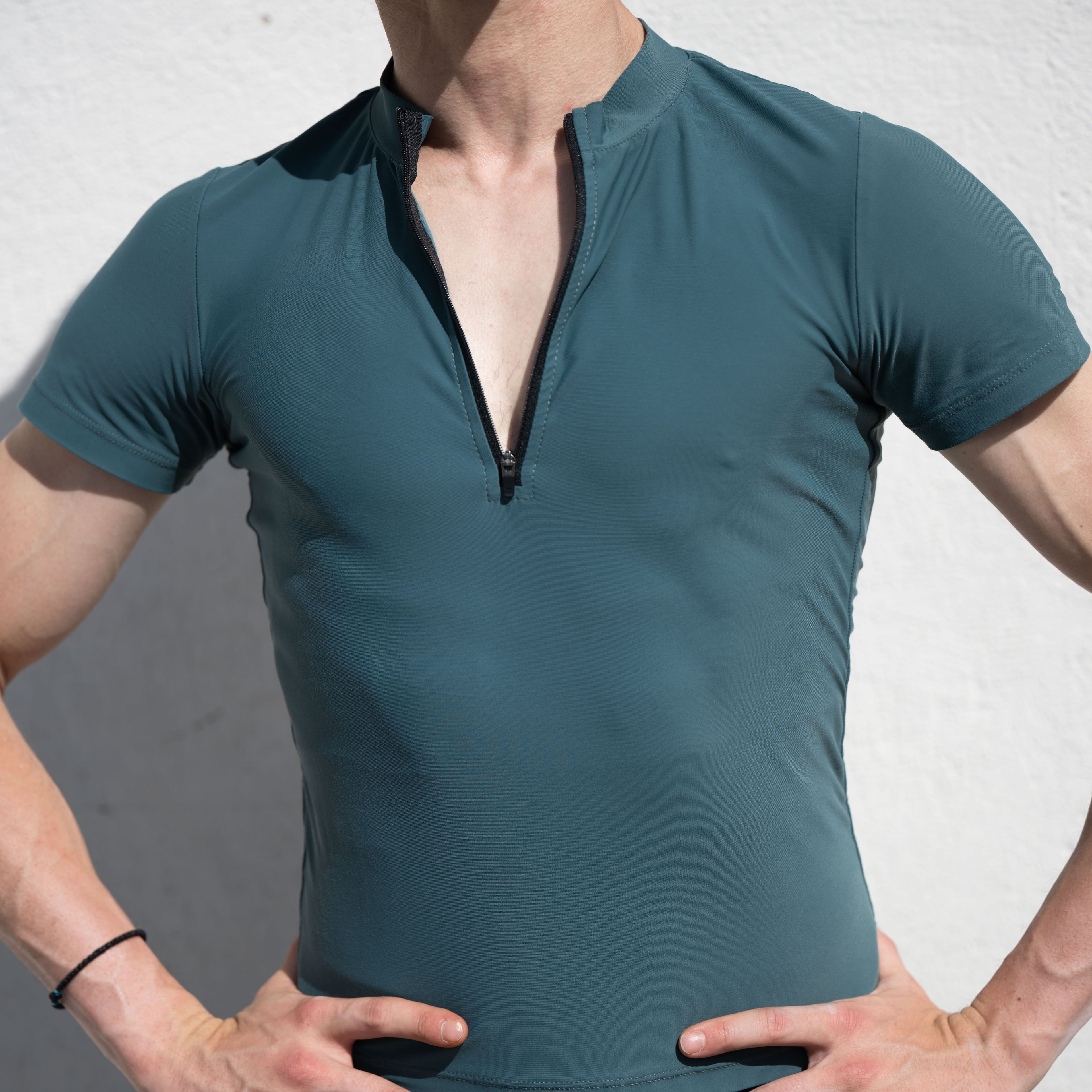 Teal athletic shirt worn by Denys Cherevychko against a neutral background